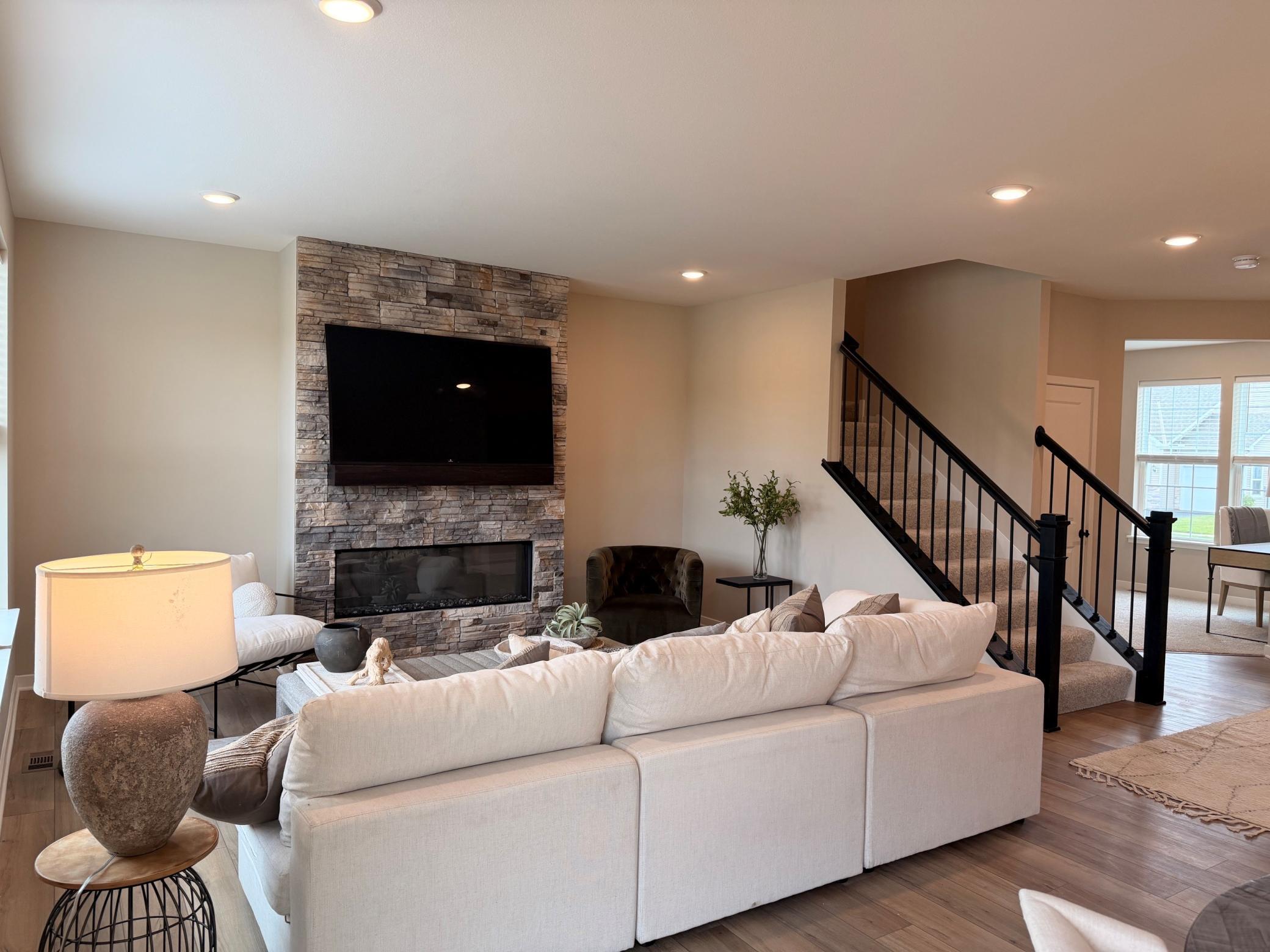 Spacious family room at the heart of the home, featuring soaring 9-foot ceilings and a cozy fireplace that adds warmth and charm.
