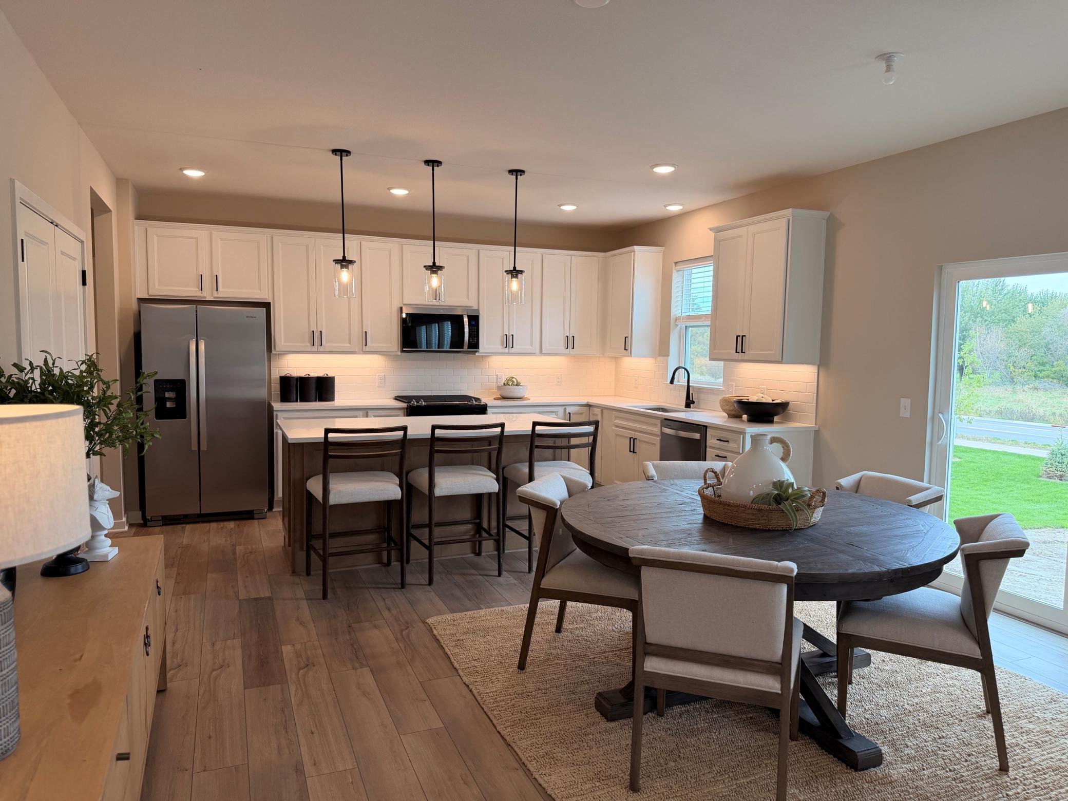 Natural light pours in through large windows, highlighting the space’s warmth and inviting atmosphere.