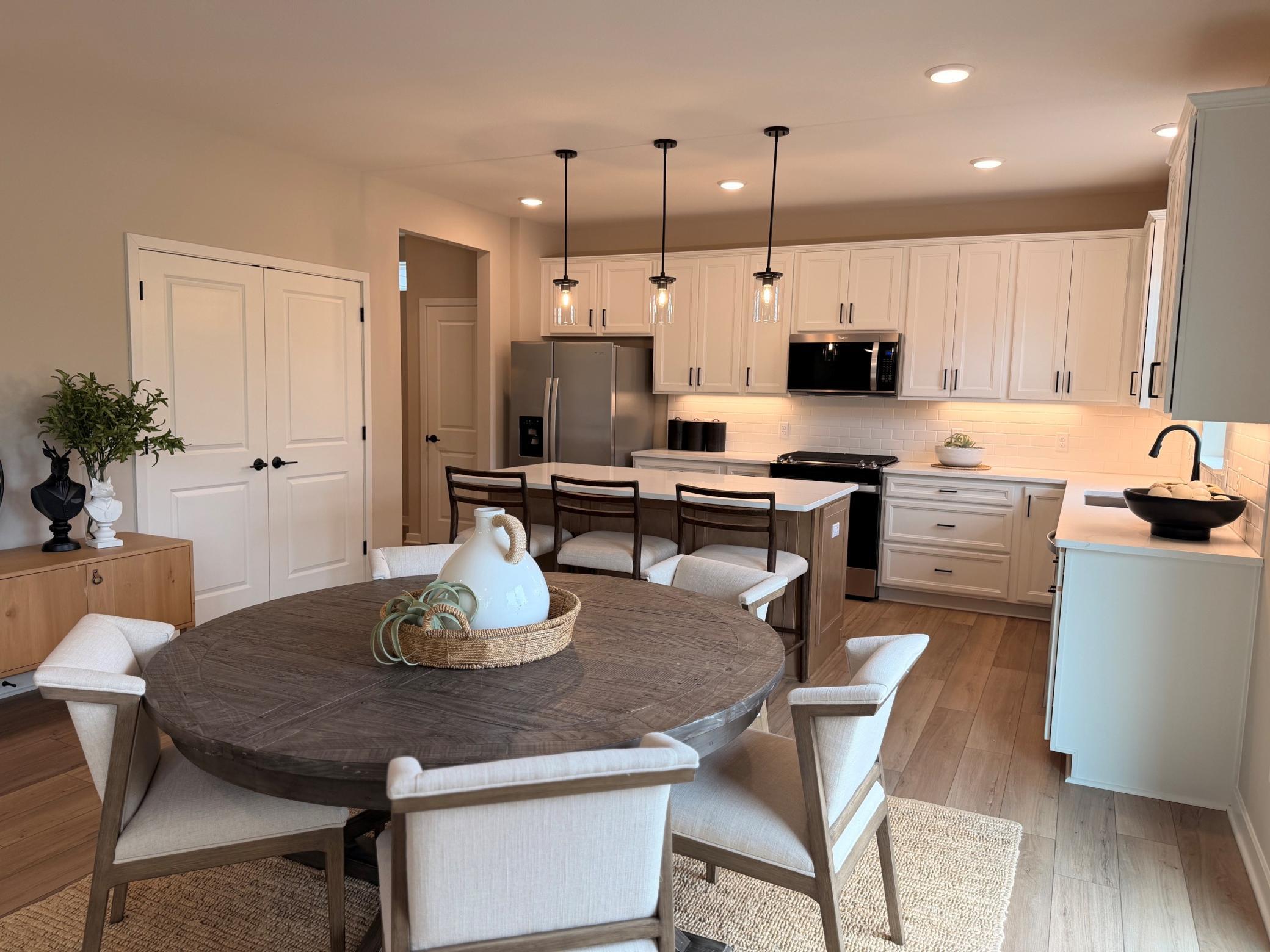 Open-concept layout connects the dining room to surrounding spaces, creating a bright and inviting atmosphere.