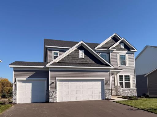 Welcome to your new home! Smooth, clean walkways guide visitors to the front door, bordered by tasteful landscaping that enhances the homeâs inviting exterior.