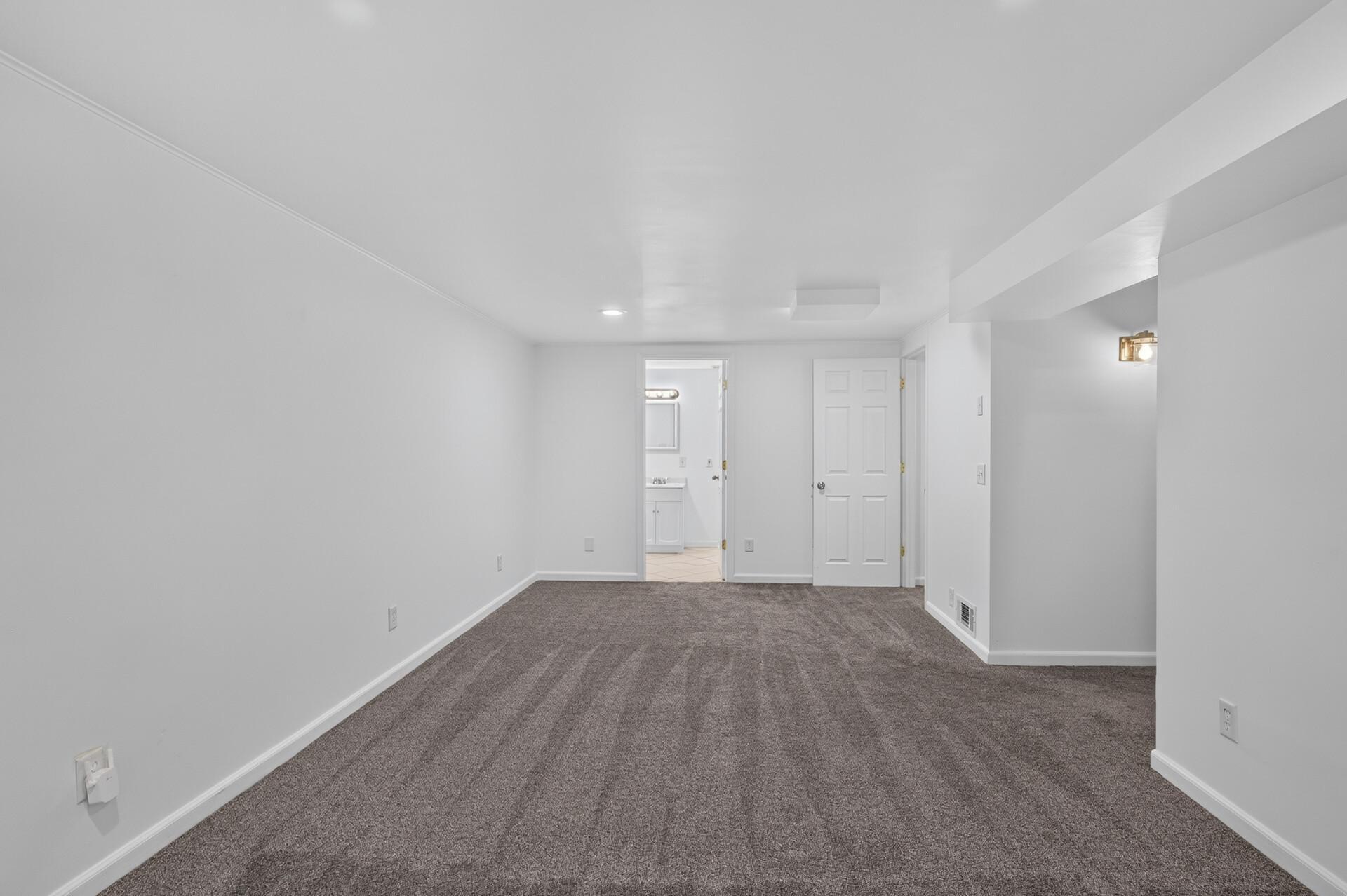 Off the family room is the full bathroom and a spacious non-conforming bedroom