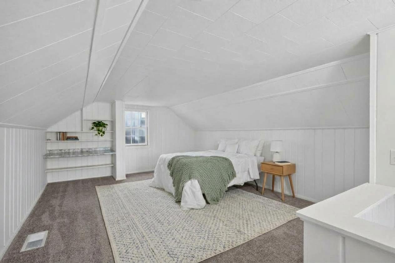 The oversized upper level bedroom has ample room for a bedroom and office space