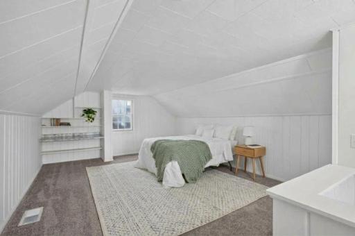 The oversized upper level bedroom has ample room for a bedroom and office space