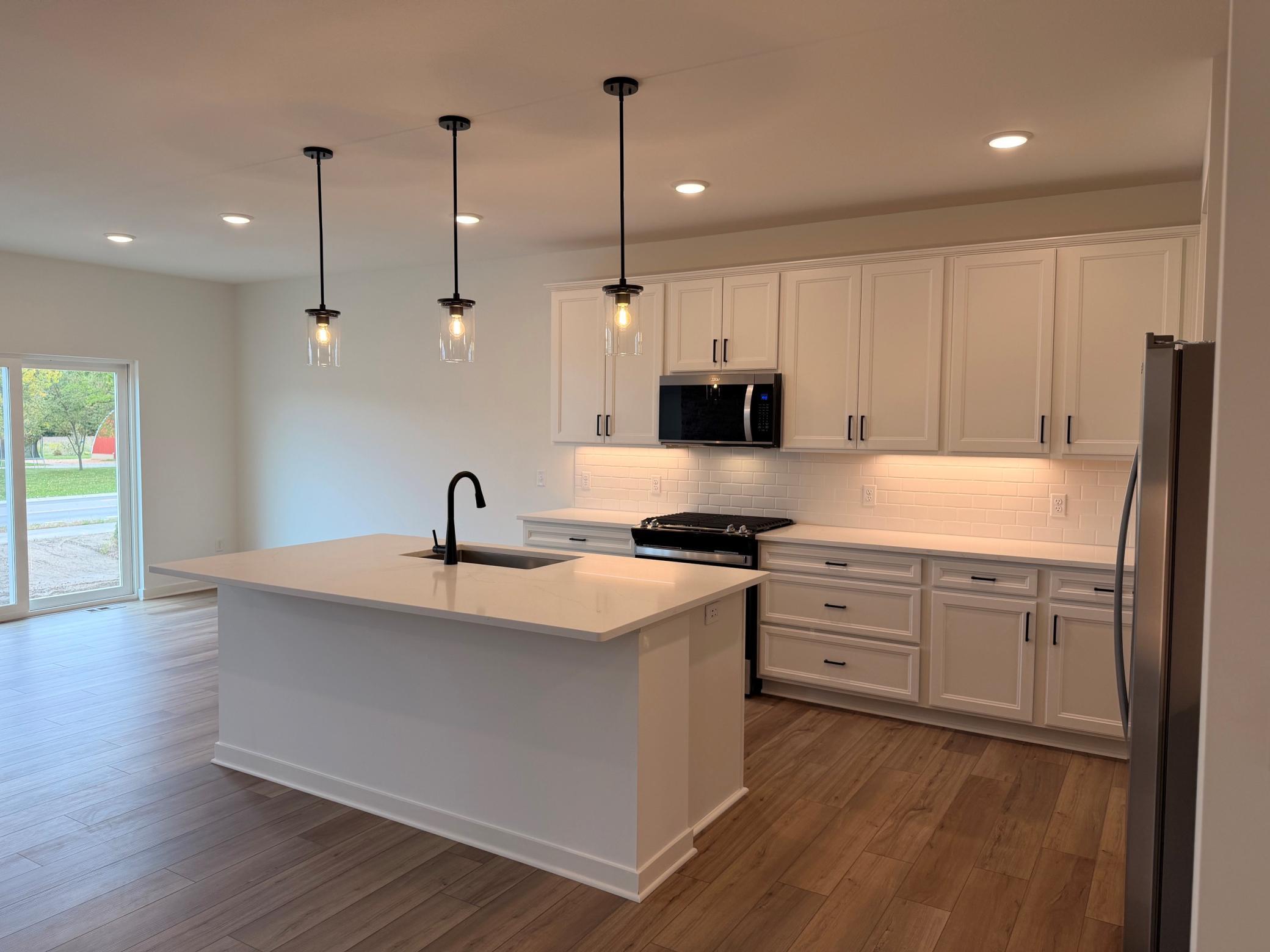 Bright and spacious kitchen featuring ample cabinetry, sleek countertops, and a functional layout—perfect for everyday living and entertaining.