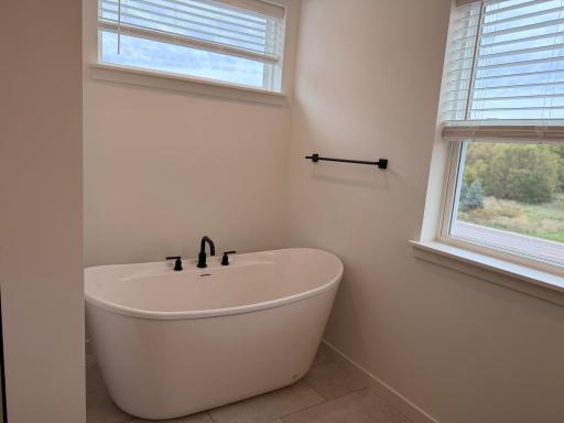 Modern fixtures and clean lines complement the thoughtful touches around the soaker tub enhance the spa-like feel, offering a private escape within your own home.