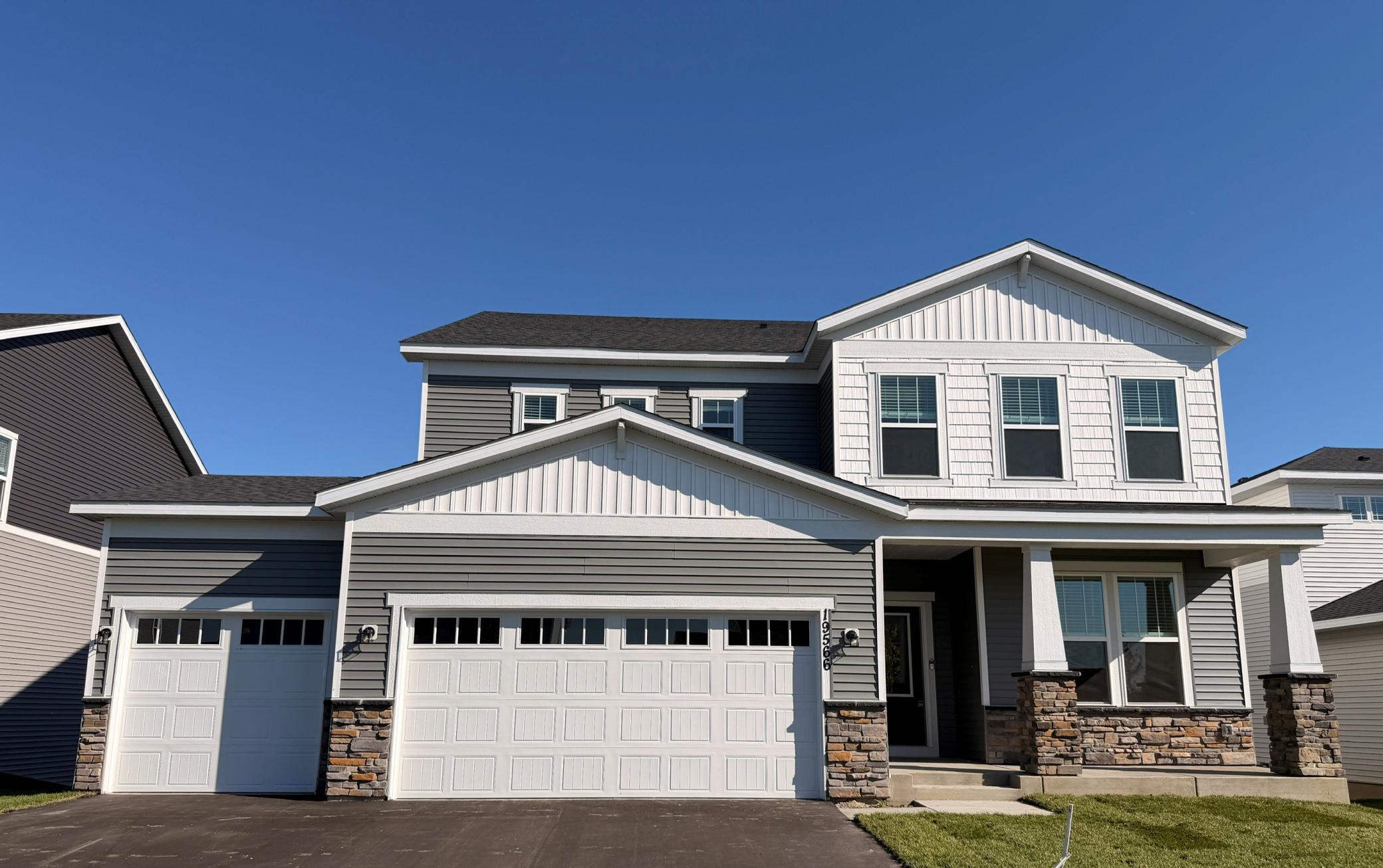 High-quality modern materials, including vinyl siding, stone accents, and contrasting trims combine to create a sophisticated and durable exterior.