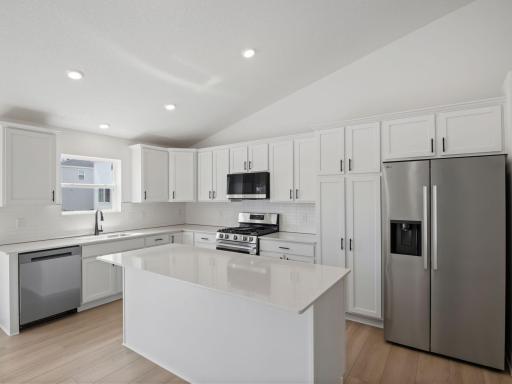 Designed for adventurous cooks, the well-equipped kitchen showcases extensive flat panel cabinetry for ample storage room, gleaming quartz countertops and cutting-edge features to simplify mealtimes.