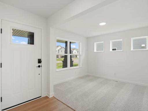 Situated on the main level at the front of the home, the flex space has a variety of possible uses such as a home office