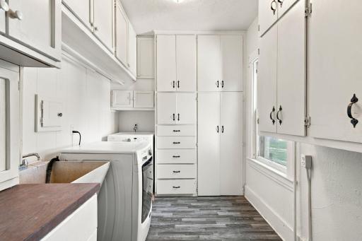 Large main level laundry room located right off the family room with tons of built in storage and utility sink!