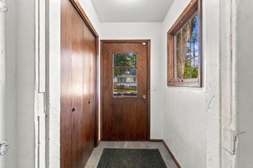Another foyer coming in off the side of the home with a coat closet and access to the lower level.