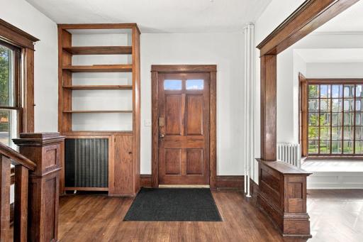Beautiful front door and refinished hardwood floors.