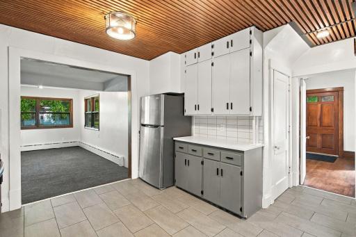 View from the kitchen to the main entry way and family room. Behind the closed door is another entryway and access to the basement.