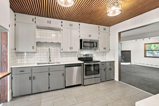 Updated kitchen with stainless steel appliances, tile flooring and accent ceiling to add texture and charm!
