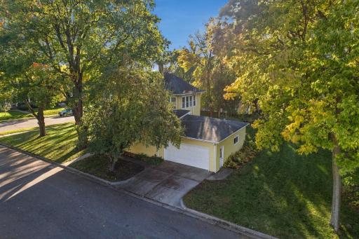 Corner lot with mature trees, 2 stall attached garage and concrete driveway.