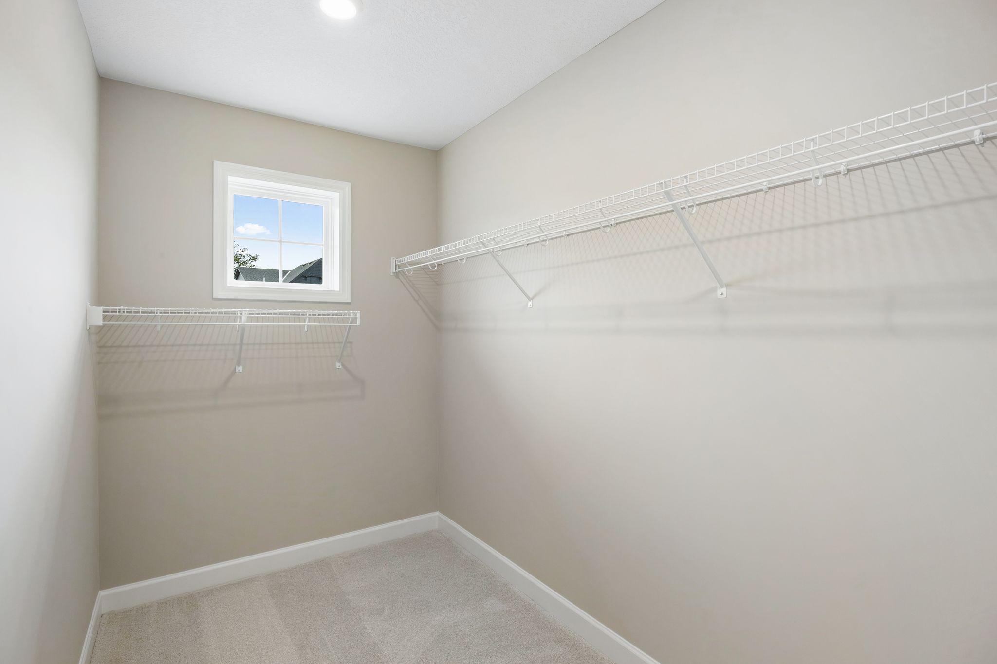 The walk-in closet offers ample space and storage