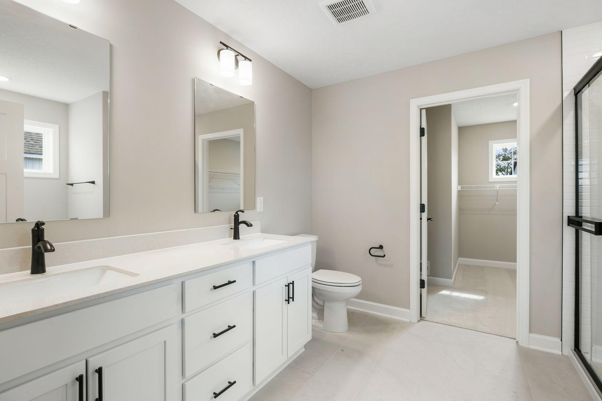 The en-suite bathroom has dual sinks to simplify any morning routine