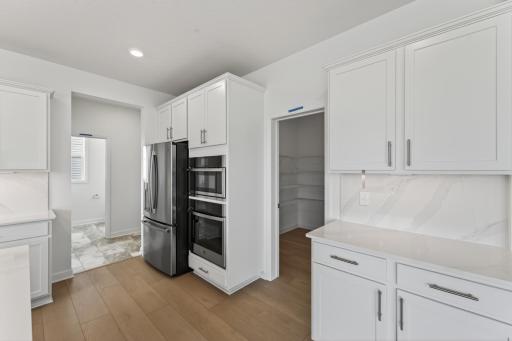 (Photo of a similar home, actual homes finished will vary) There is a walk-in pantry off the kitchen.