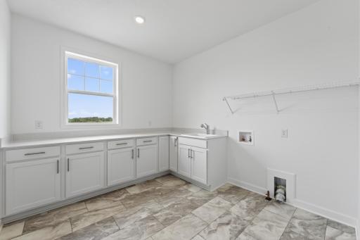 (Photo of a similar home, actual homes finished will vary) The main level laundry room.