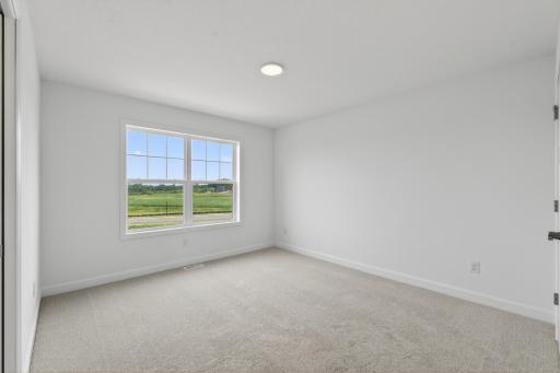 (Photo of a similar home, actual homes finished will vary) One of the three secondary bedrooms.