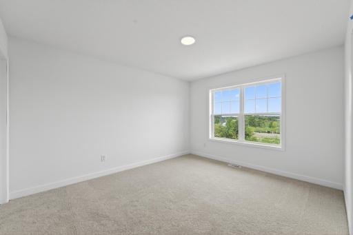 (Photo of a similar home, actual homes finished will vary) One of the three secondary bedrooms.