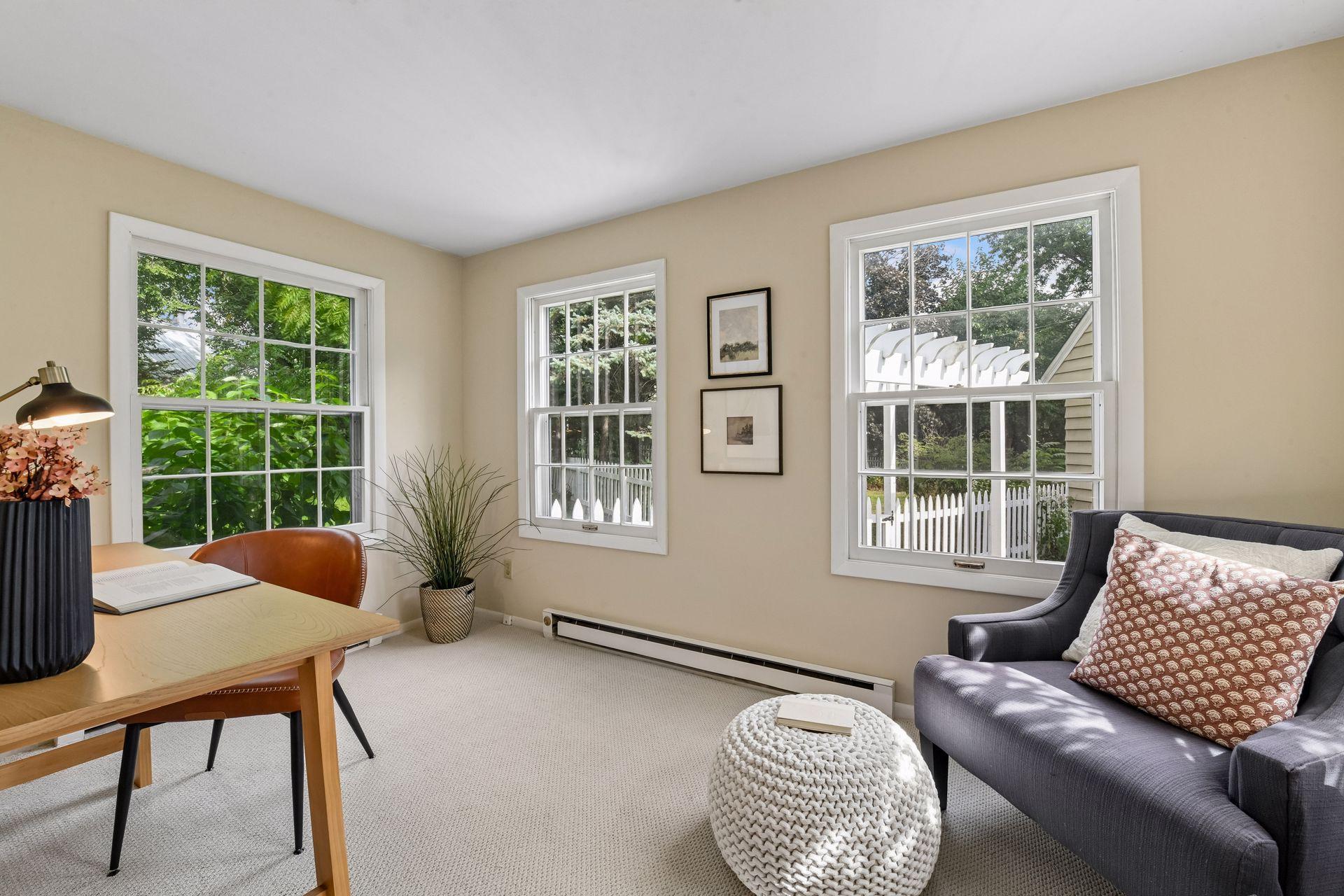 Bright, versatile sunroom surrounded by windows and natural light. An ideal spot for a home office, reading room, or quiet retreat.