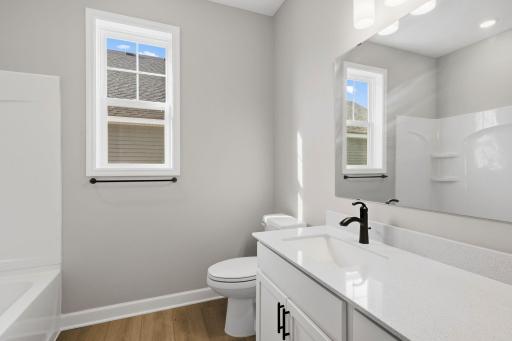 This full-sized bathroom is arranged near the secondary bedrooms in a well-thought-out design to promote balanced living.