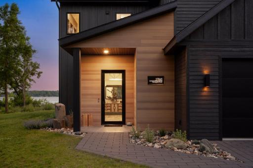 Greet your guests with a permeable paver driveway and walkway that leads to the home surrounded by professionally designed landscaping.