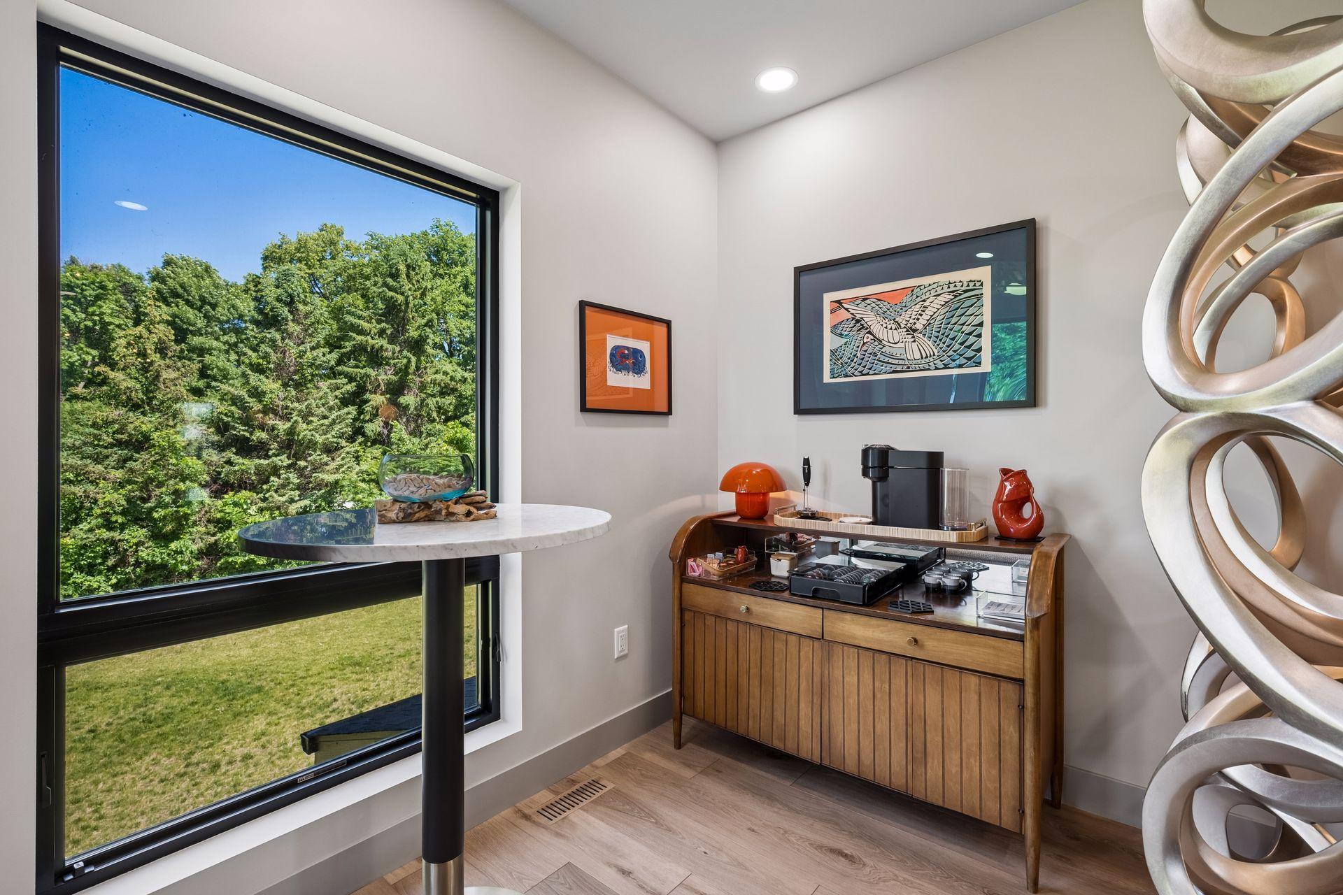 The coffee bar adds convenience, creating the perfect space to start the day or unwind while enjoying this comfortable upper-level gathering area.