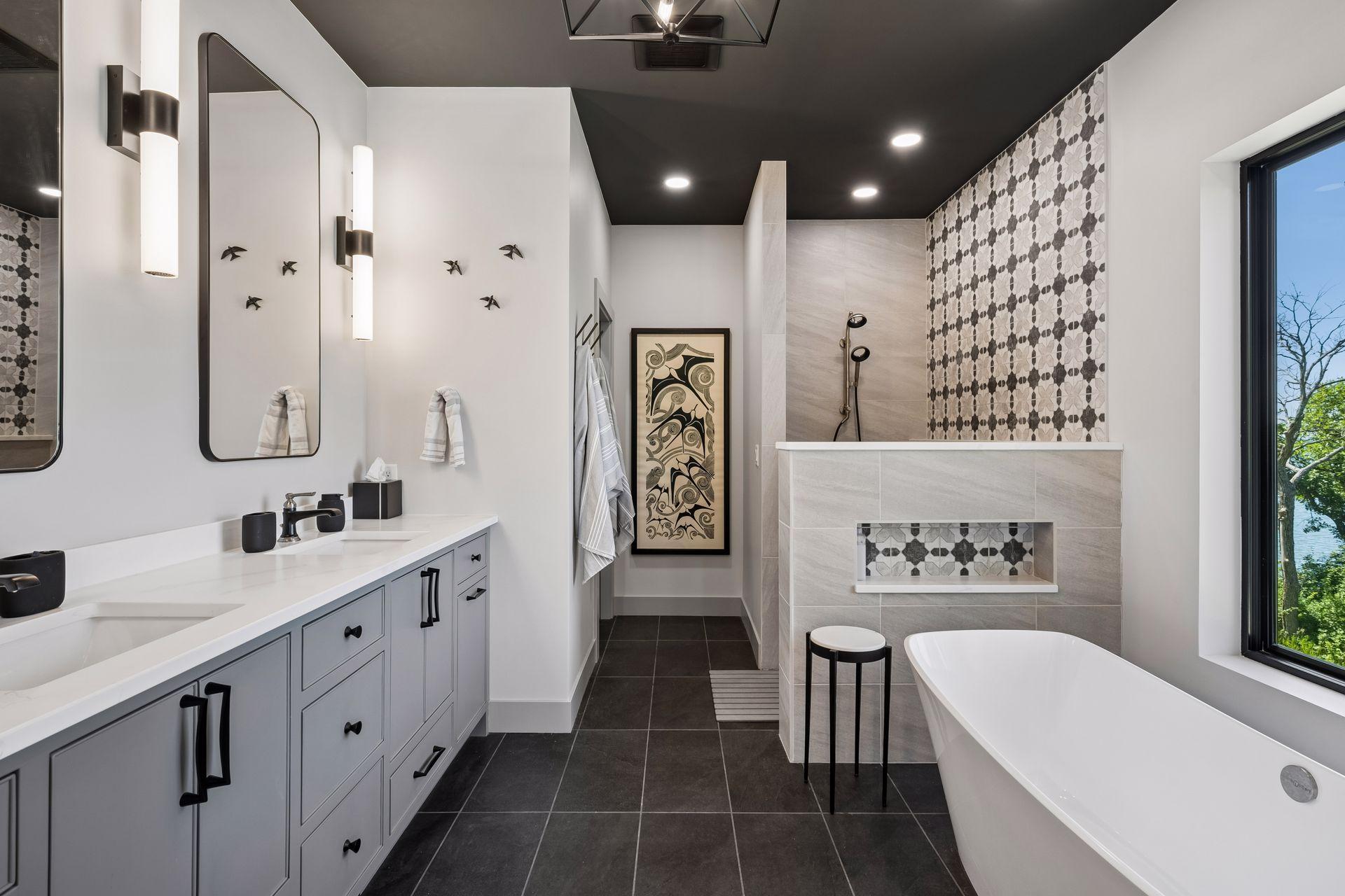 The spa-inspired primary bath is designed as a private sanctuary, featuring a freestanding soaking tub perfectly positioned to capture breathtaking lake views.