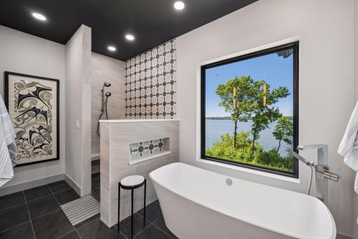 A spacious walk-in tile shower with designer finishes, dual-sink vanity, and thoughtfully selected fixtures create a luxurious retreat where comfort and relaxation take center stage.
