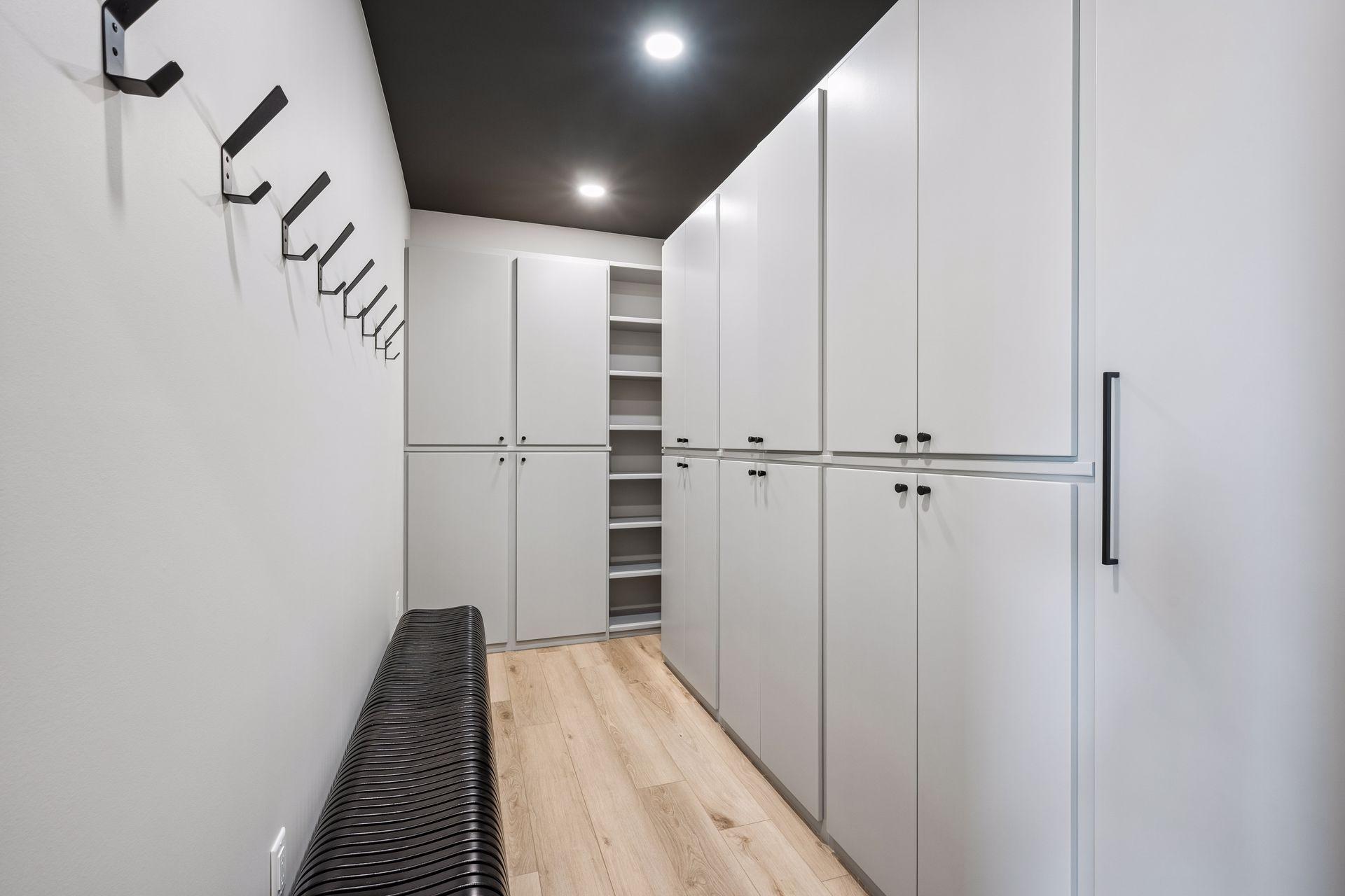 The spacious primary walk-in closet is thoughtfully designed with custom cabinetry, shelving, and storage solutions to keep everything organized and easily accessible.