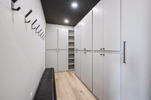 The spacious primary walk-in closet is thoughtfully designed with custom cabinetry, shelving, and storage solutions to keep everything organized and easily accessible.