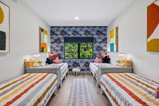 This thoughtfully designed bunk room maximizes sleeping capacity without the use of traditional bunks, offering greater flexibility, comfort, and safety for guests of all ages.
