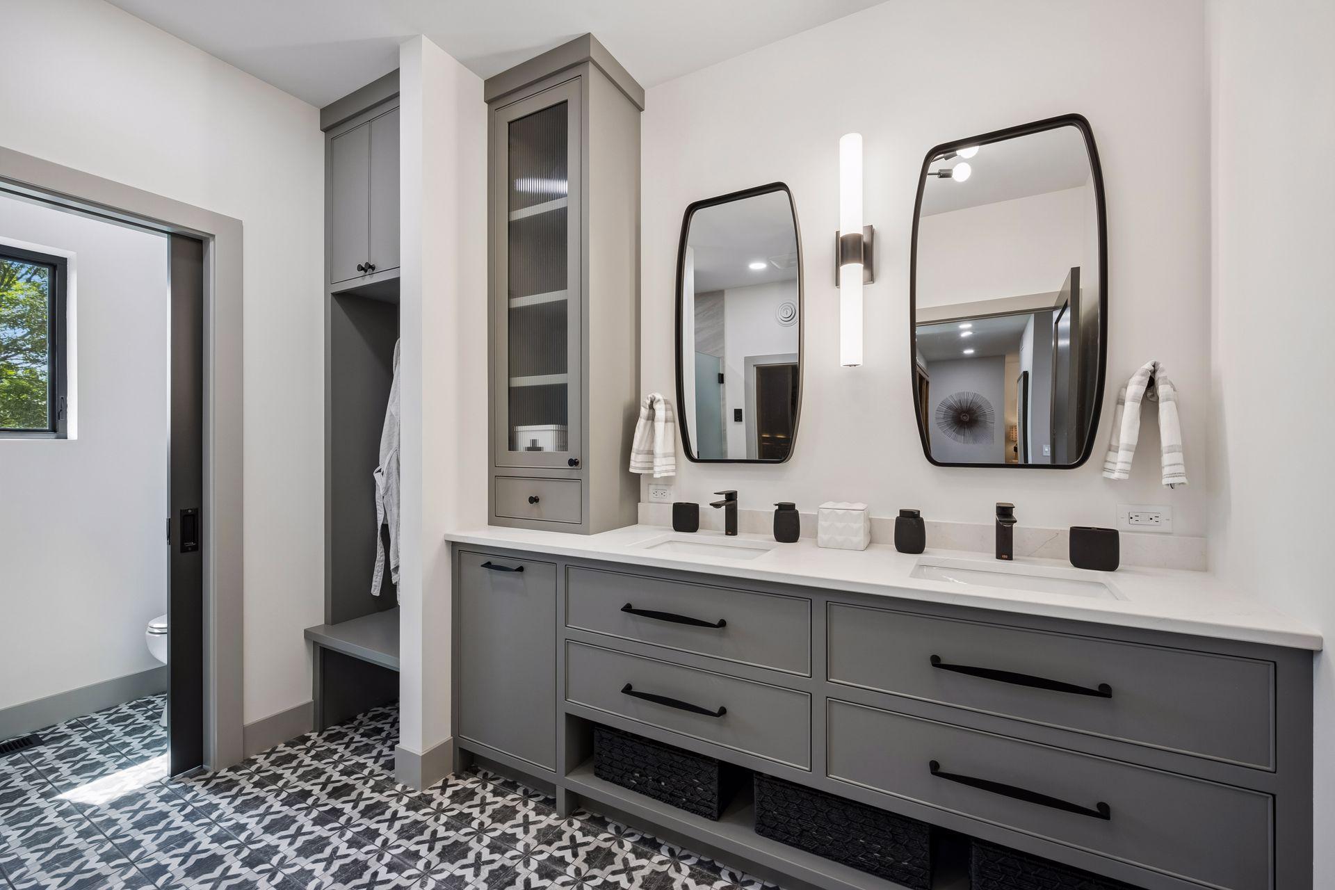 This well-appointed bathroom serves as a private extension of the guest suite, featuring a dual-sink vanity, custom cabinetry, dry sauna and designer finishes throughout.