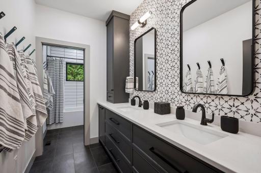 This spacious upper-level bedroom offers a private retreat complete with its own luxurious bath, accent wall and double sinks. All upper bathrooms feature in-floor hot water heat.