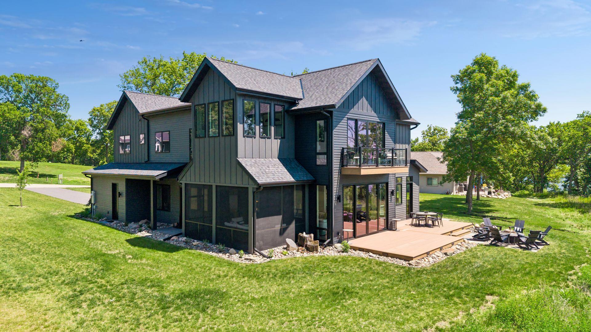 The outdoor living spaces have been thoughtfully designed for entertaining and relaxation, featuring a spacious patio and dedicated grilling area with a natural gas connection.