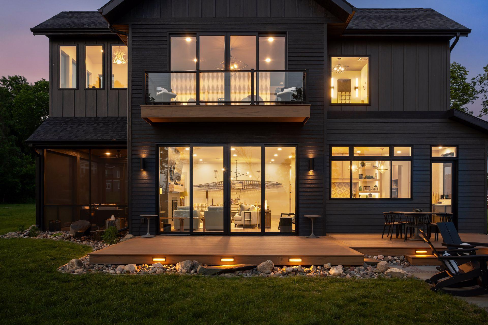 Thoughtful lighting, expansive windows, and warm interior glow combine to create a resort-like atmosphere that is equally inviting by day or night.