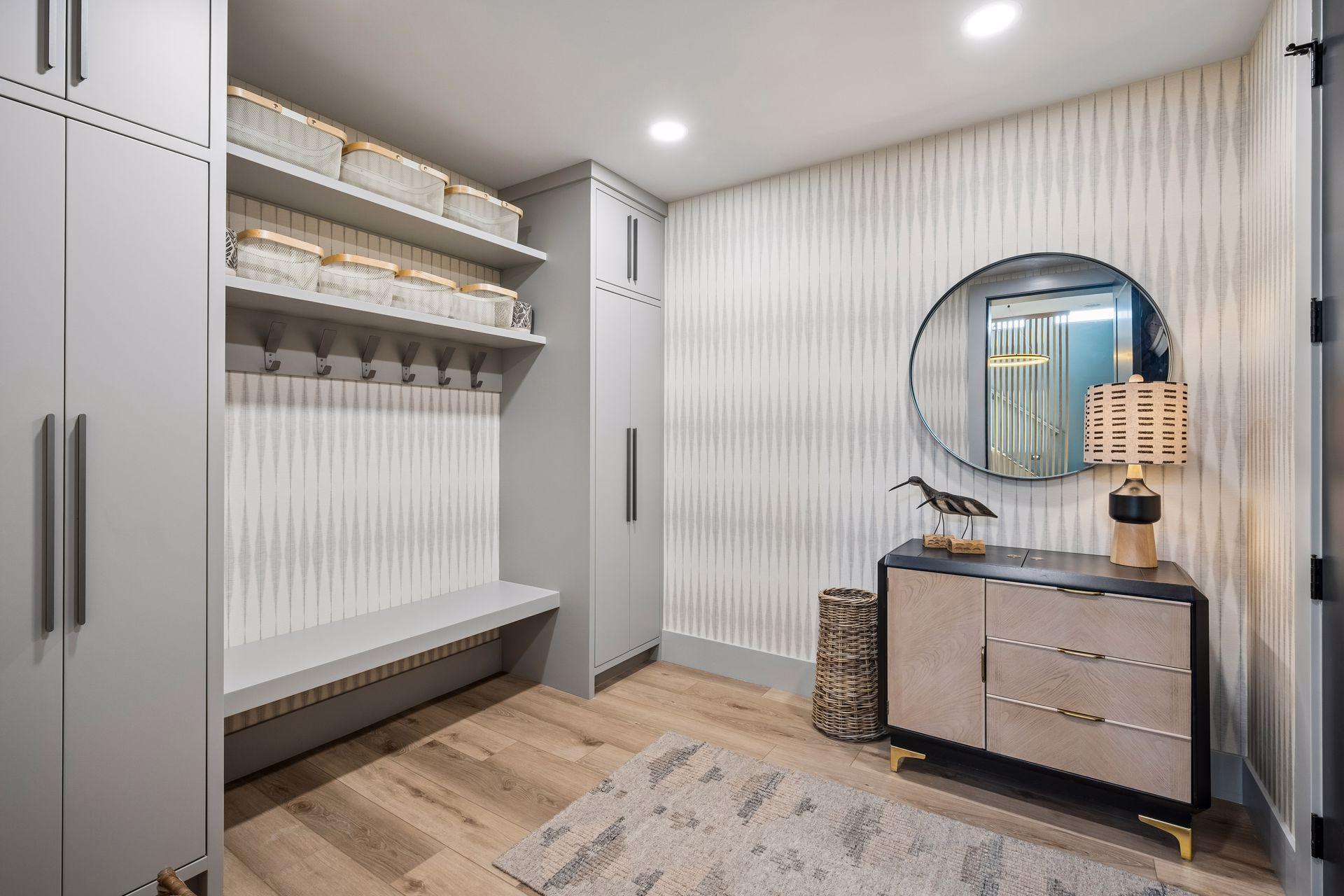 The thoughtfully designed mudroom combines style and function with custom built-in cabinetry, open storage, and a convenient bench for everyday organization. This room also doubles as a storm shelter.