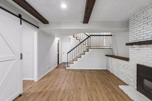 Lower level view from patio door. The white door in the back of photo is the entrance through the garage.