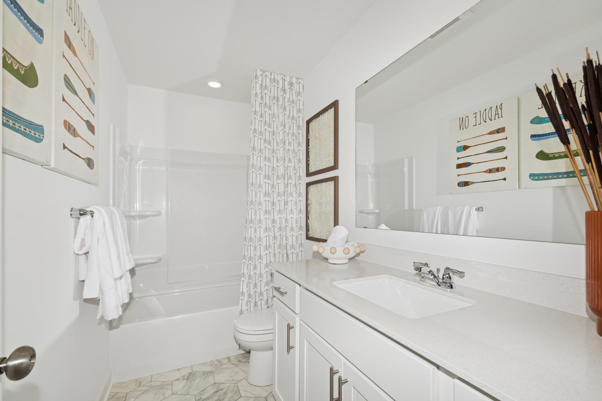 (Photo of model home, features will vary) A full-sized bathroom on the second floor comes well-equipped with a generously sized quartz-topped vanity and a combination shower and tub to maximize the interior space.