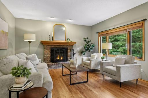 The adjoining family room, anchored by a cozy fireplace, creates a comfortable gathering space.