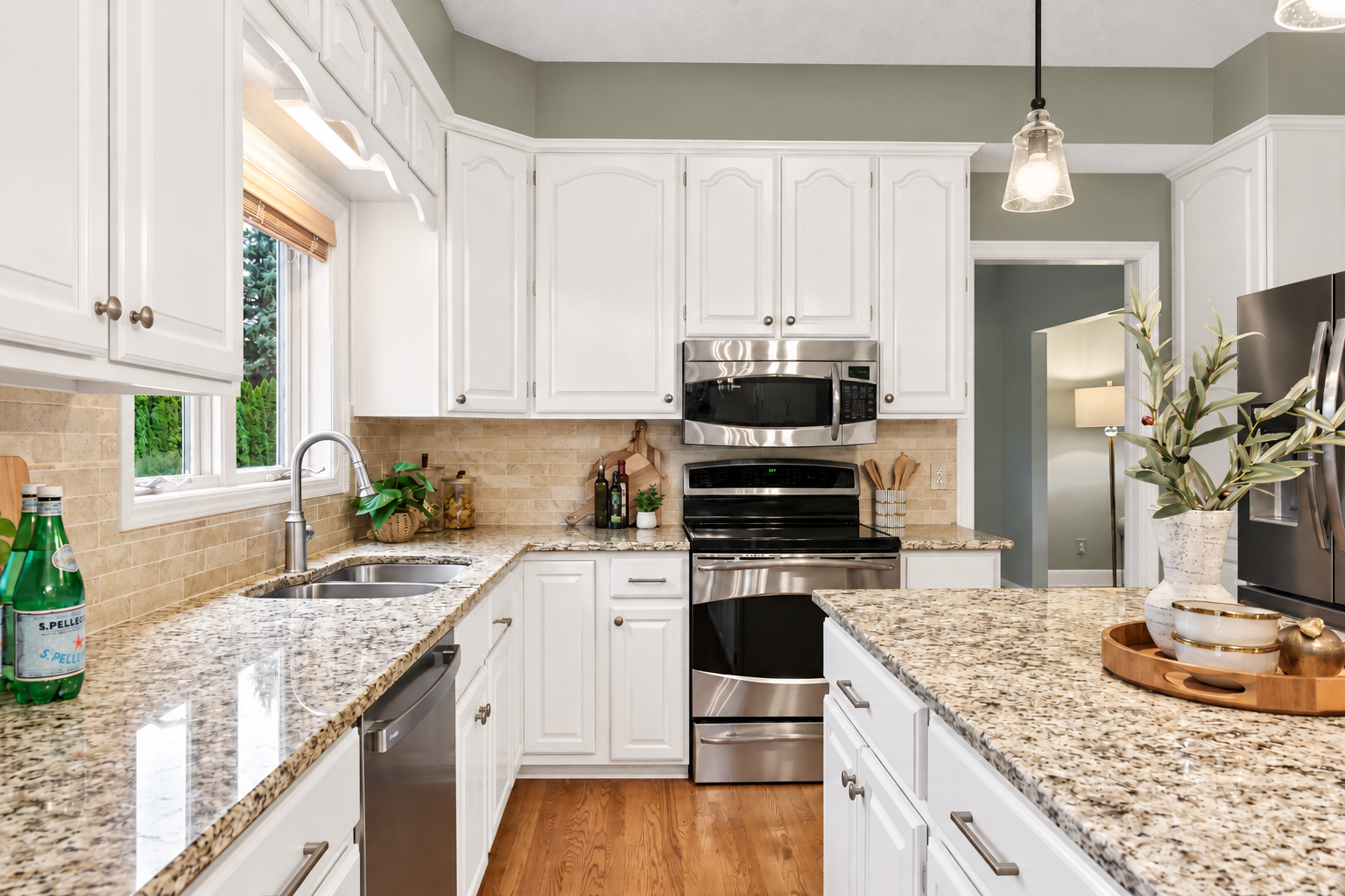 Photo has been digitally enhanced to illustrate how the kitchen could look with white enameled cabinetry.