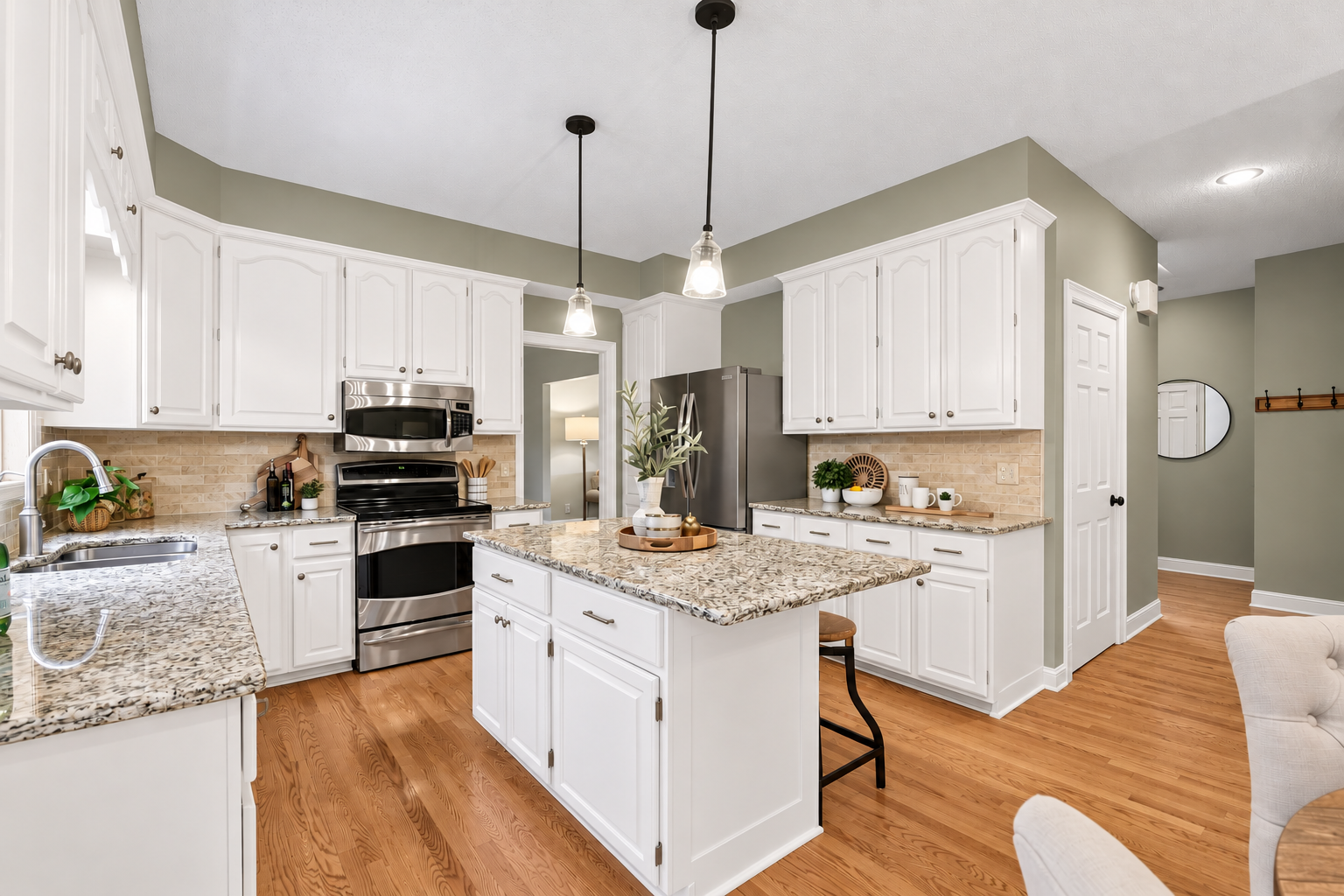 Photo has been digitally enhanced to illustrate how the kitchen could look with white enameled cabinetry.