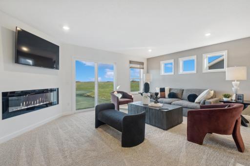 (Photo of a decorated model, actual homes finishes will vary) Light-filled great room that is located on the same upper floor as the bedrooms - a complete custom feel.