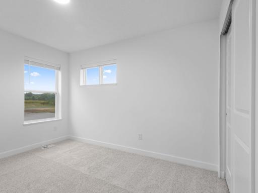 Each bedroom in the home includes a practical wardrobe closet and wall-to-wall carpeting for a plush underfoot feel.