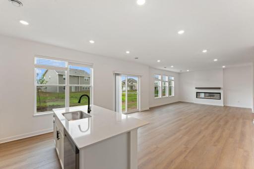 The center island has an open line of sight to the dining and living areas of the home