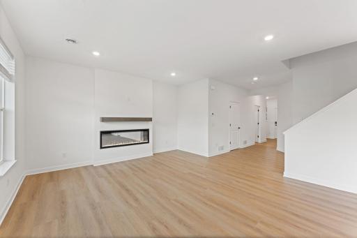 Shaw luxury vinyl plank flooring runs throughout the foyer, Great Room and other select parts of the home