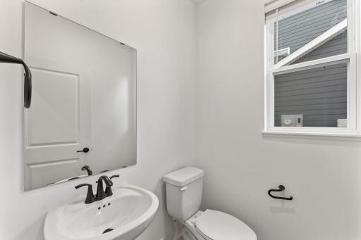 Found off the Great Room is a convenient powder room to meet the needs of the whole household, as well as visiting guests.