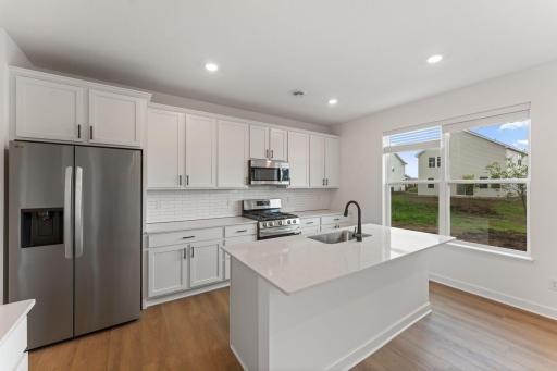 (All the following photos are of a similar home, actual finishes may vary.) Blending style and functionality effortlessly, the kitchen features ample cabinet space, durable quartz countertops and a set of all-new stainless steel appliances.