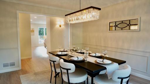 The sophisticated and stunning formal dining room, right off of the kitchen, can house a large dining table perfect for both dinner parties and holiday celebrations.